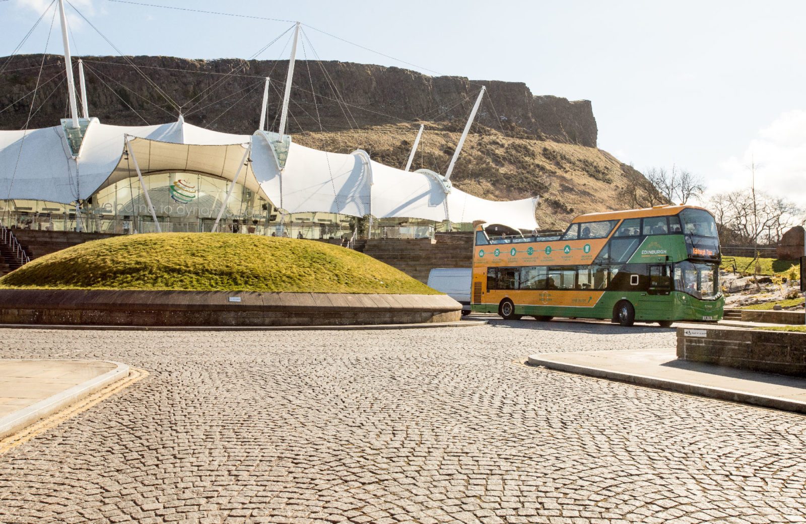 Edinburgh Tour Bus on the foreground with Arthur's Seat in the background